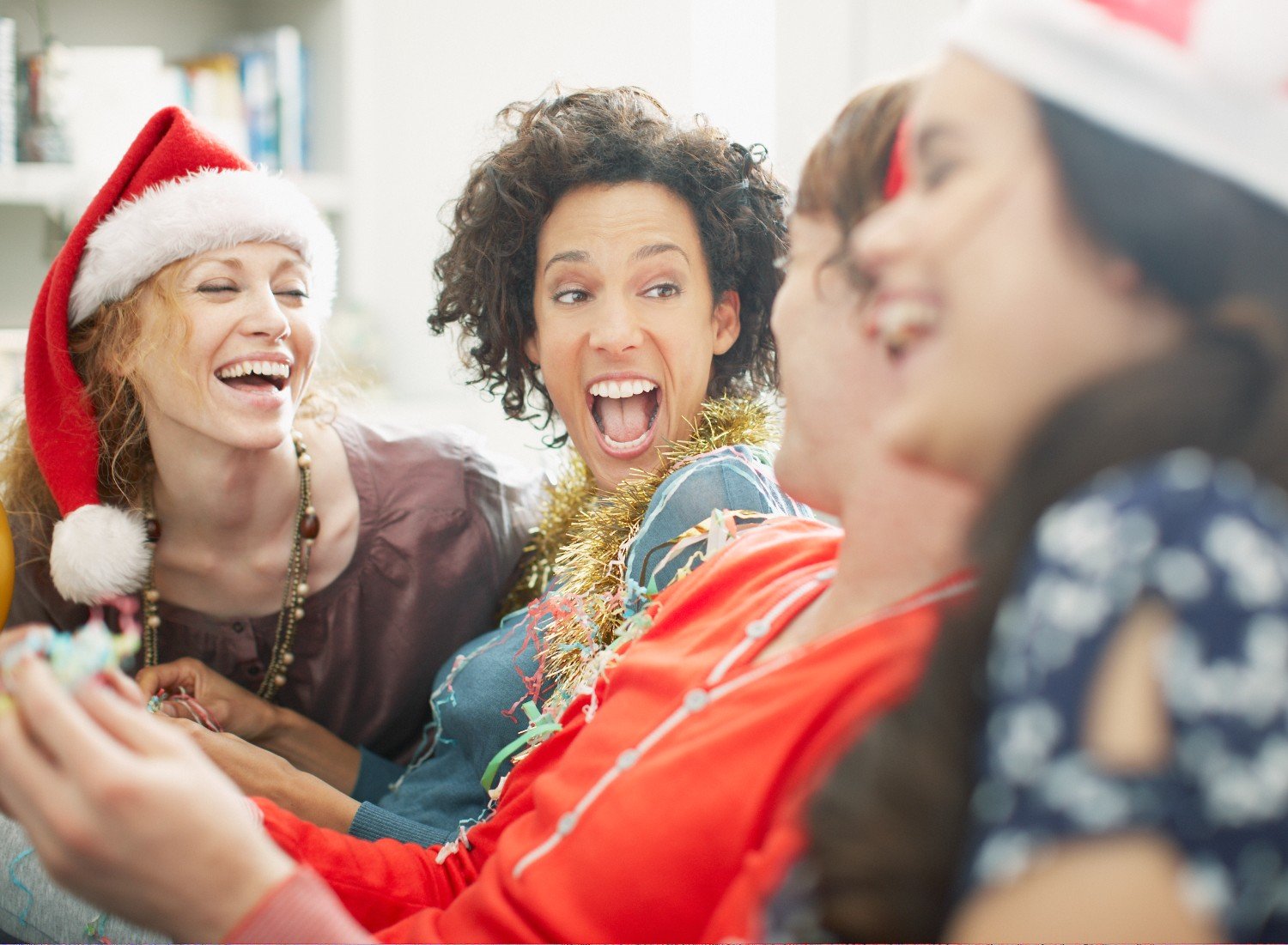 Women laughing wearing festive clothing