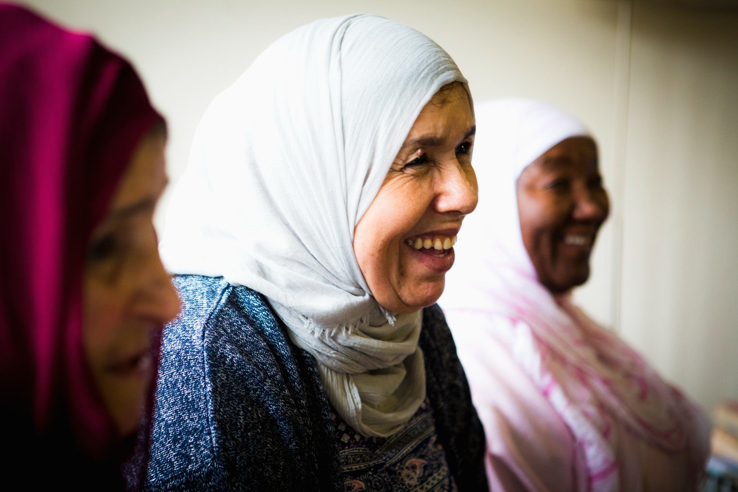 three women wearing hijab smiling 