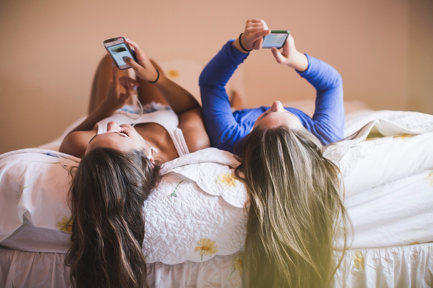 : two teenage girls on mobile phones 