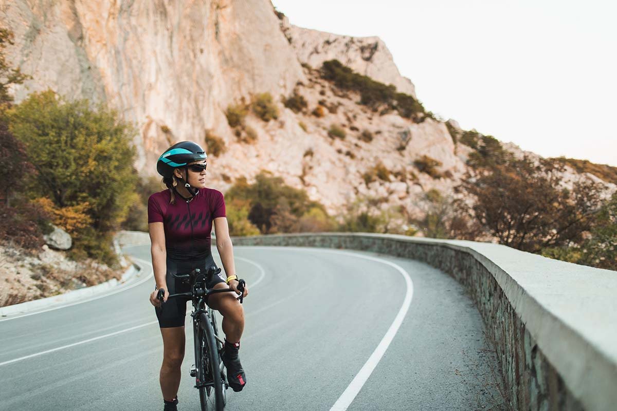 Woman cycling through mountains