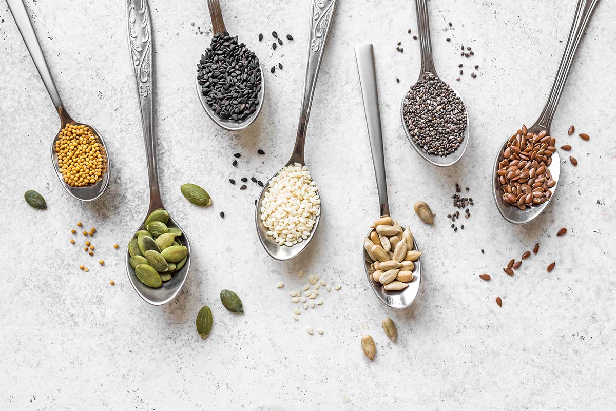 mixed seeds on cooking spoons 