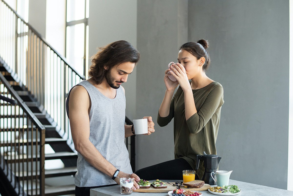 Couple at breakfast drinking hot beverage