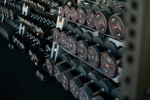 Black and red dumbells in a gym setting