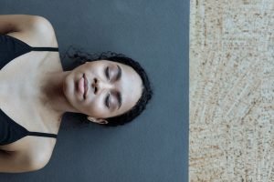 woman relaxing on a yoga mat