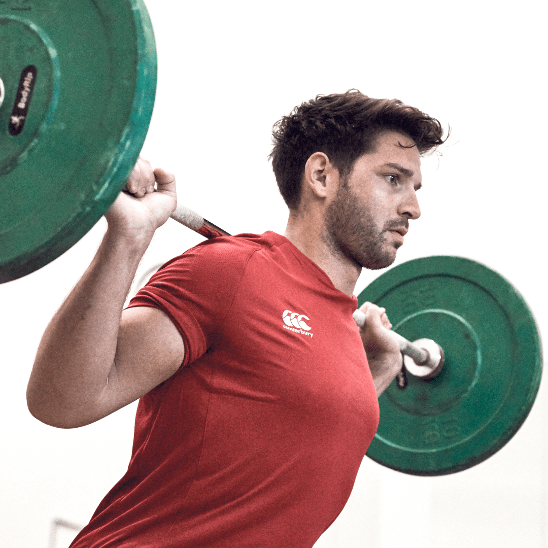 Man squatting in Canterbury gear