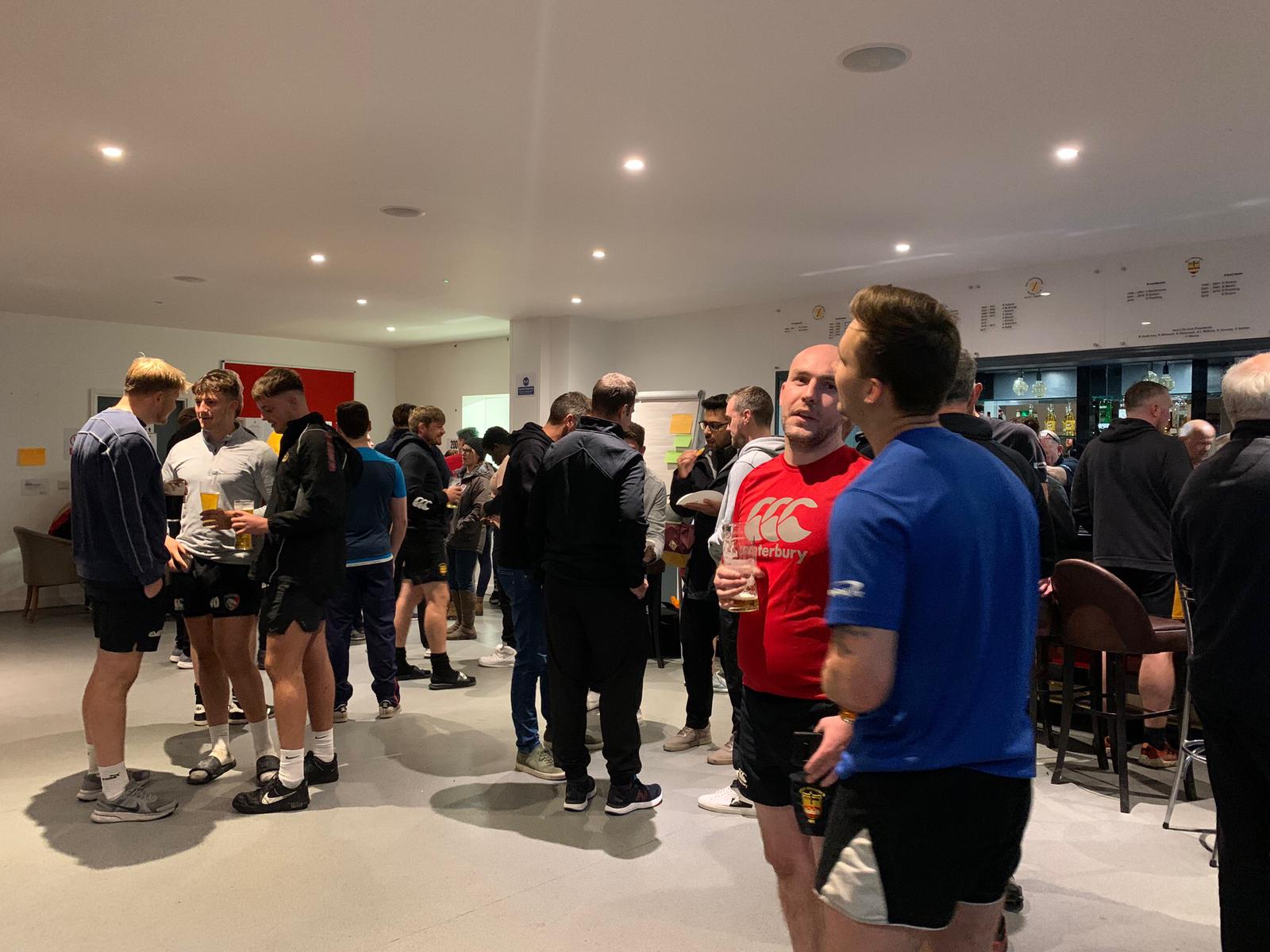 Community gather in Canterbury gear inside clunhouse