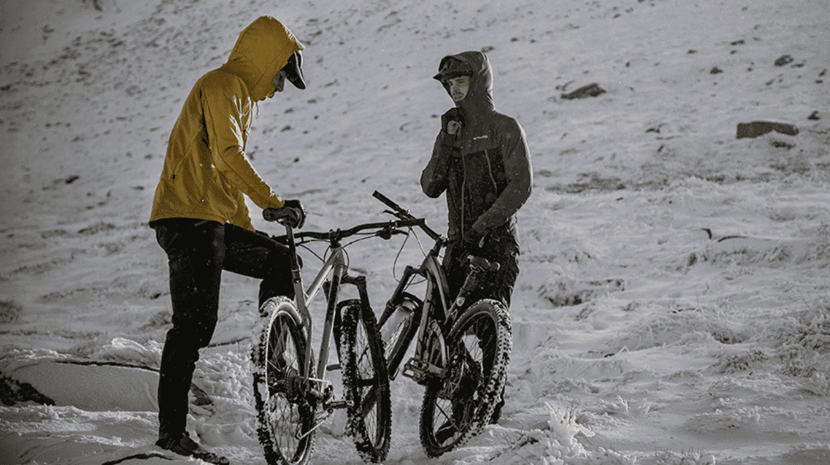Two riders preparing in the snow