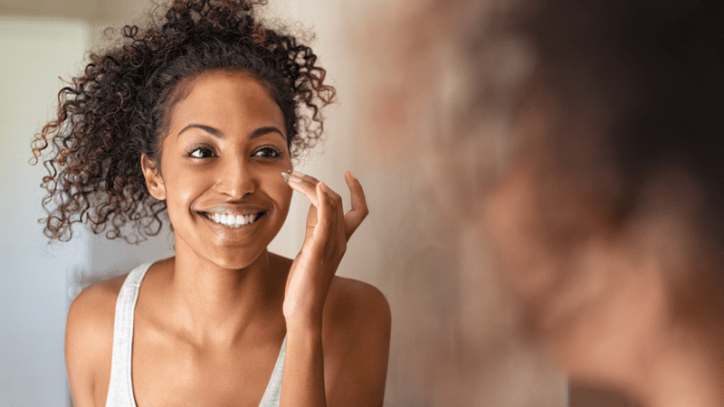 woman applying moisturiser 