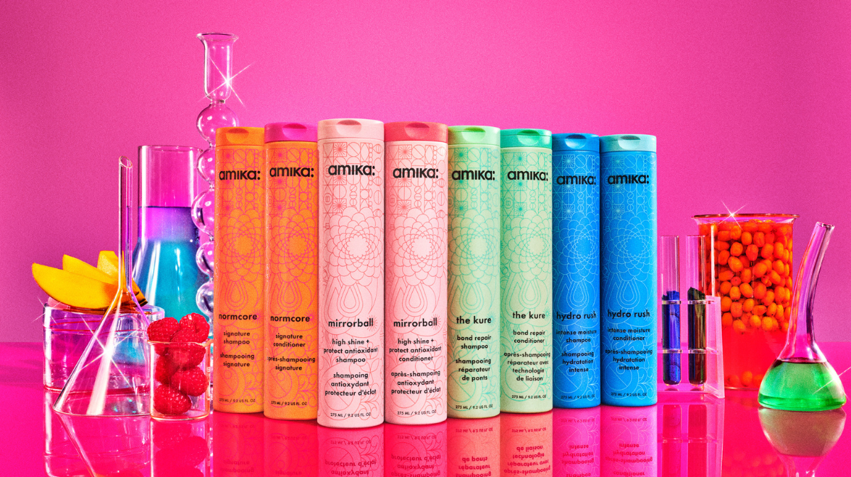 Amika shampoo and conditioners lined up on a pink background