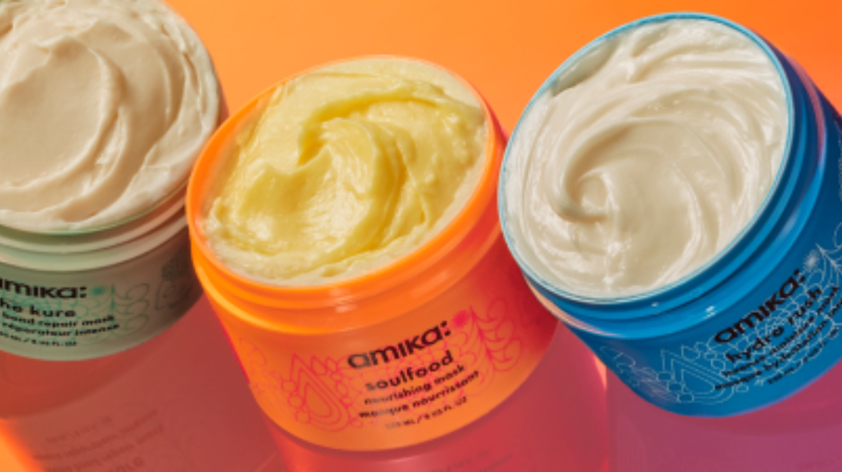 Amika hair masks in a row open on an orange background