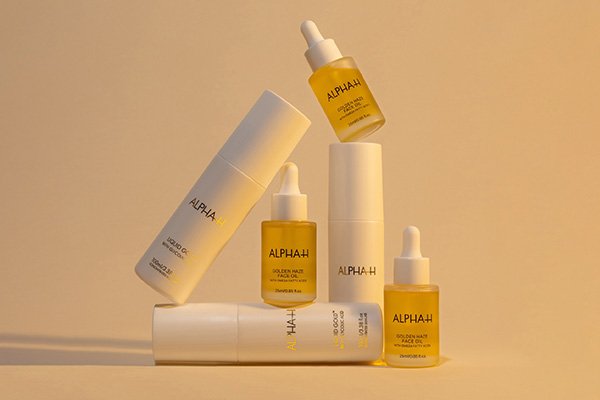 6 Alpha H products perched on top of one another against a yellow background