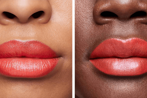 two models one dark skinned one medium skinned both wearing red lipstick