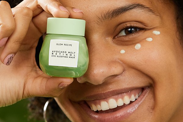 woman with eye cream holding glow recipe product