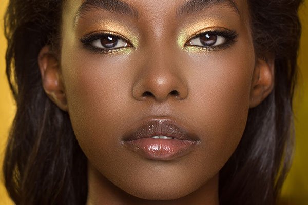 model with golden eye make up