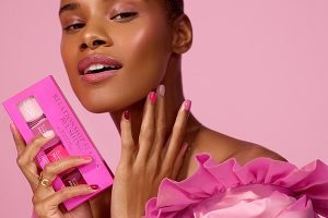 dark skinned model wearing pink with pink nails