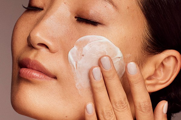woman moisturising her face