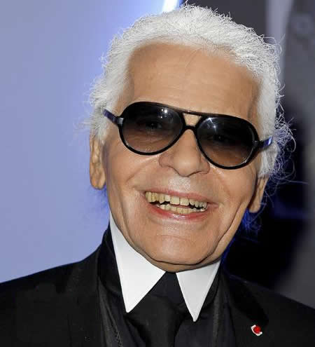 Karl Lagerfeld displays missing teeth as he flashes a broad grin