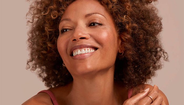 Smiling woman with smooth, glowing skin.