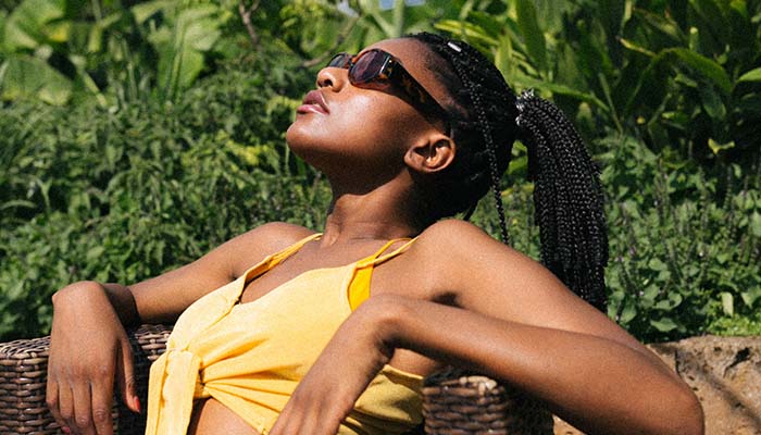 Model leaning back, her face in the sun