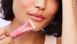 close up of a models lips holding lanolips
