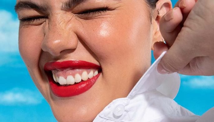 model smiling with bright red lips