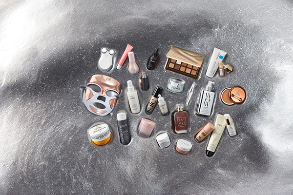 A selection of pre black Friday beauty products from LED masks to skin care and make up, sat on silver slime. 