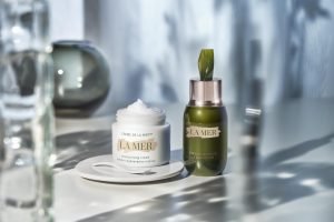 two la mer products: creme de la mer and le concentrate surrounded by glass vases