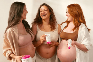 Three pregnant mothers, one with brown hair, one with curly and one with red hair all holding different mama mio products