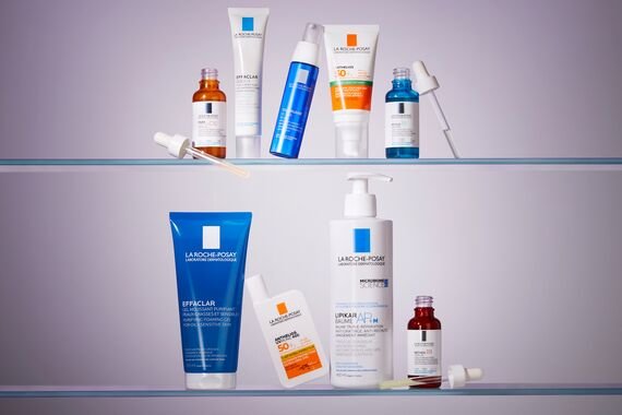 two clear shelves each containing a row of la roche posay skin care products
