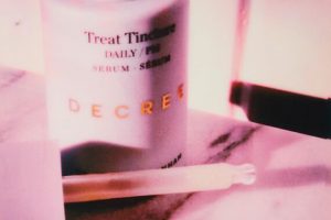 decree skin care serum open with the pipette next to the bottle
