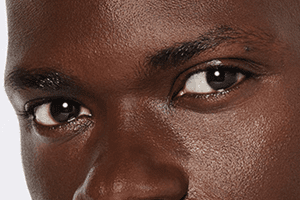 nars light reflecting foundation in shade mali on a dark skinned male model