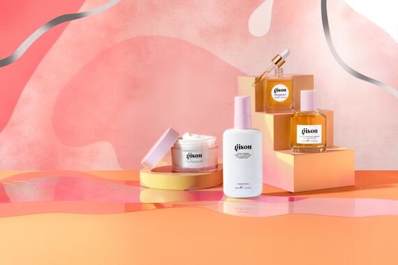 GISOU hair care set against a pink/orange background
