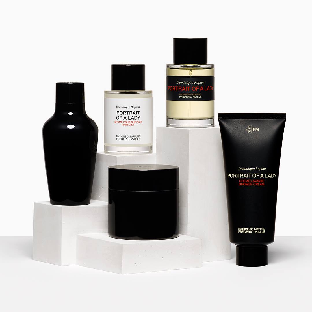 frederic malle portrait of a lady perfume and body wash against a white backdrop, surronded by two black vases