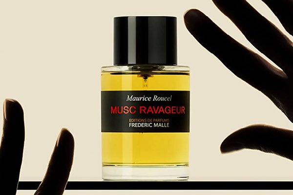 frederic malle perfume bottle with two dark hands trying to grab it