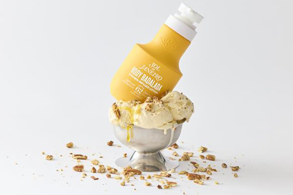 Sol de Janeiro's Body Badalada Lotion shot against a background of ice cream
