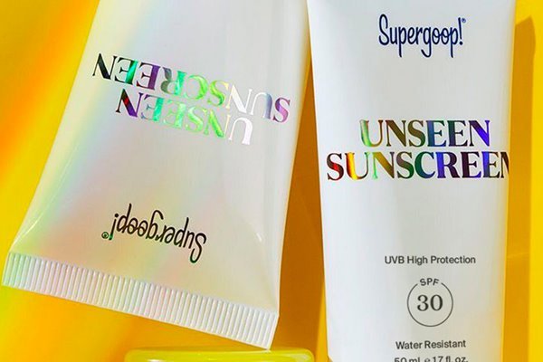 two bottles of two supergoop unscreen spf on a yellow background