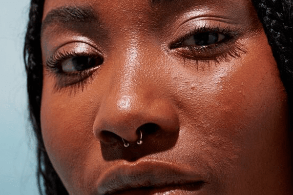 close up of a dark skinned model's face showing her texture