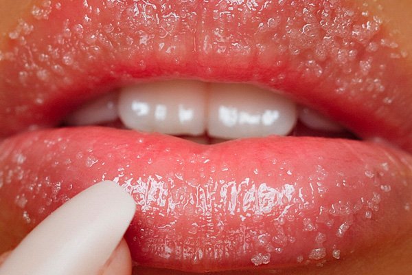 Woman applying lip balm 