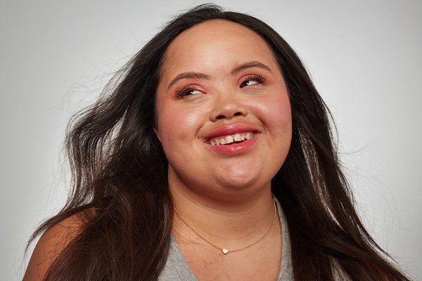 Model with flowing hair against a grey background