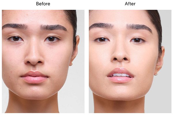 A close up of a before and after image of a female model wearing Hourglass’ Vanish Airbrush Concealer in shade Apricot. 