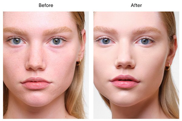 A close up of a before and after image of a female model wearing Hourglass’ Vanish Airbrush Concealer in shade Oat. 