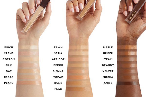 A image of three different arms with different colour skin tones showing Hourglass’ Vanish Airbrush Concealer swatches. 