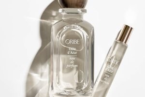 a full size and travel sized bottle of oribe cote d'azur perfume shot against a white background.