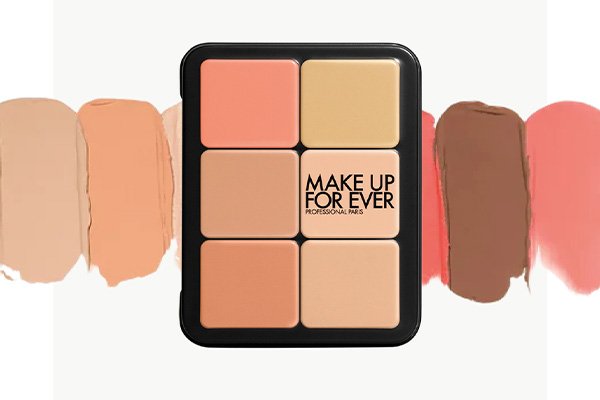 a make up for ever all in one palette shot against five swatches of the palette. shot in a studio