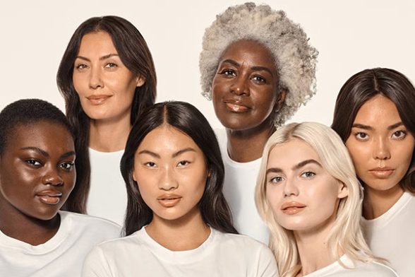 Image of female models of all ages and skin tone with demure make up, in a studio setting, in front of a white background.