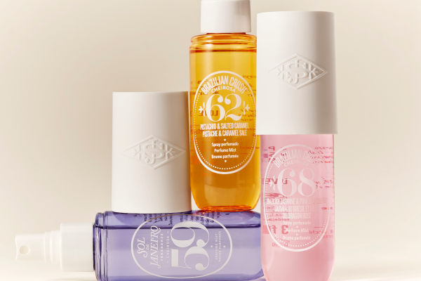 An image of three different Sol de Janeiro’s body mists stacked up against each other, in a studio setting, on beige background.