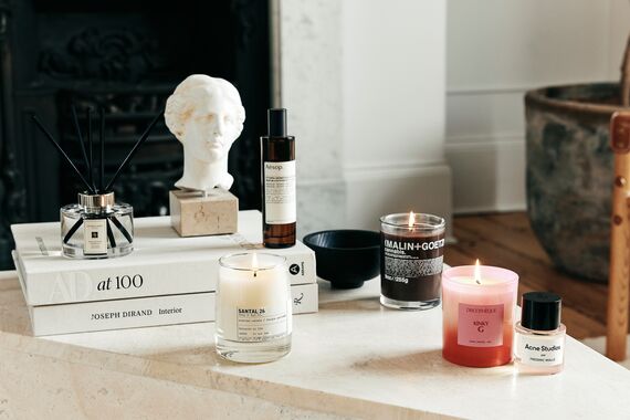 A selection of Cult Beauty's products scents for the home placed on a coffee table