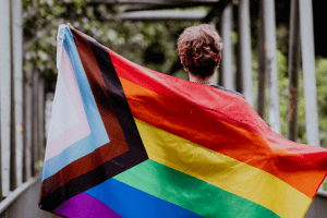 person holding an lgbtq flag