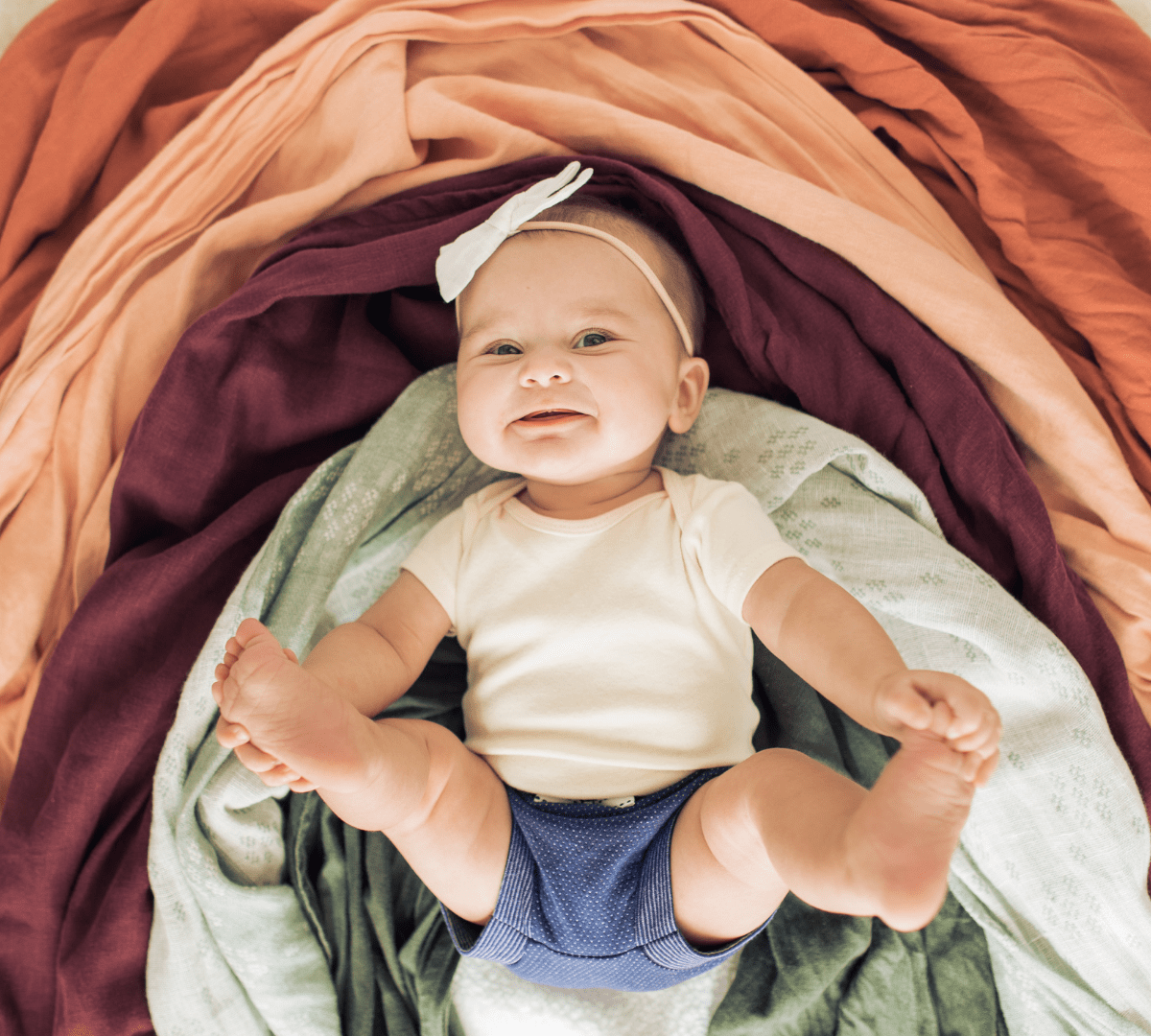 baby with rainbow blankets
