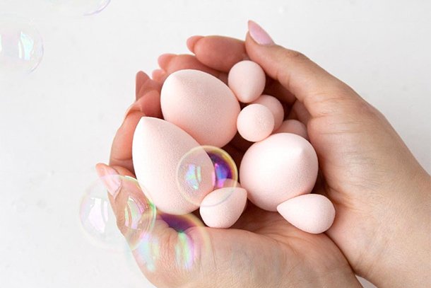 a handfull of baby pink beauty blenders